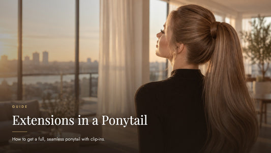 Woman with a long full light ash-brown high ponytail seen from behind in a sunlit loft at golden hour, captioned Extensions in a Ponytail - Sandy Bella clip-in ponytail guide