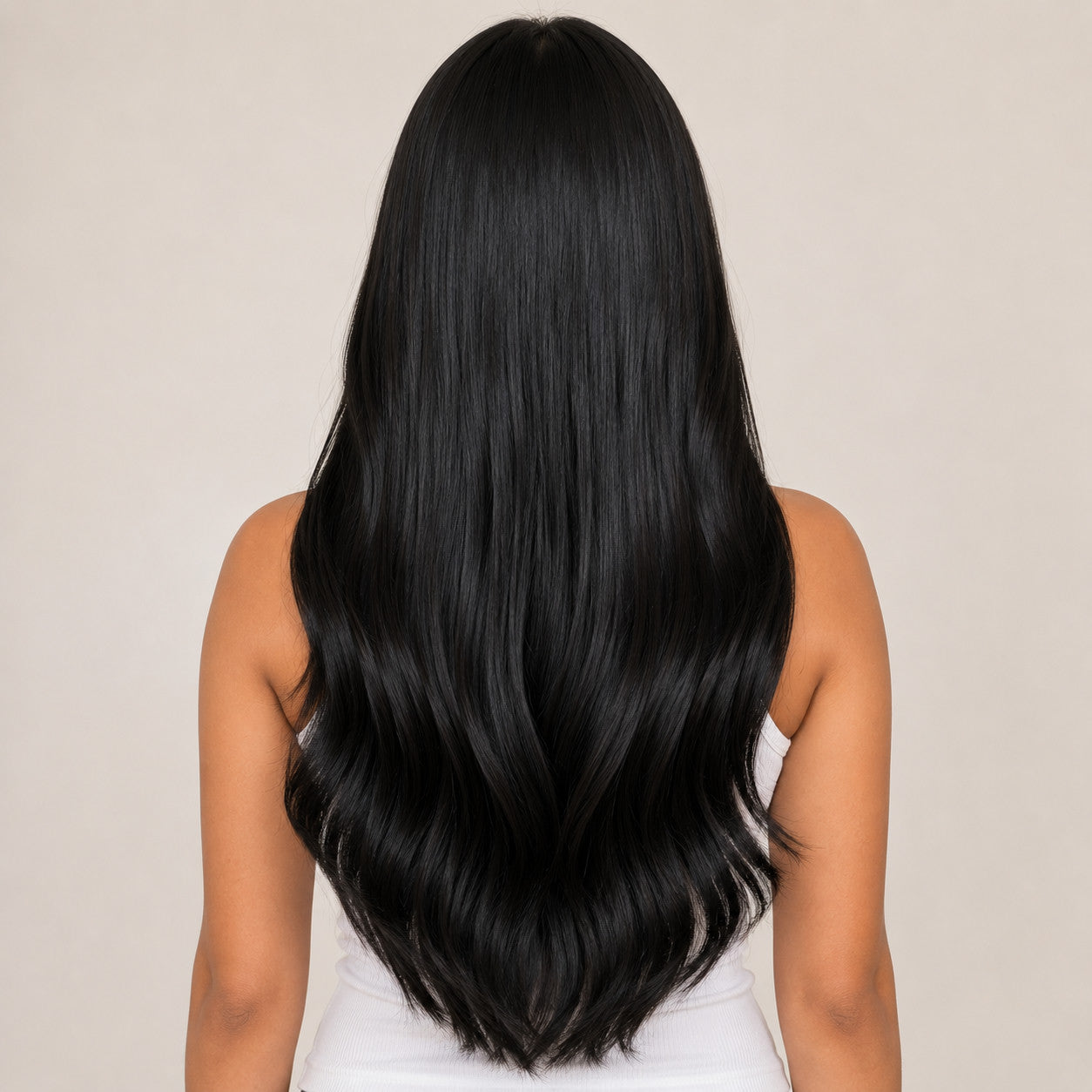 #1 Natural Black 20 inch clip-in hair extensions worn, back view showing full length and soft waves - Sandy Bella